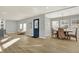 Dining area with hardwood floors and a rustic wooden table with wicker chairs at 8810 Beechwood Ave, Indianapolis, IN 46219