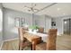 Bright dining area with hardwood floors and a rustic wooden table with wicker chairs at 8810 Beechwood Ave, Indianapolis, IN 46219