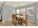 Dining room with a rustic wooden table and wicker chairs at 8810 Beechwood Ave, Indianapolis, IN 46219