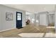 Bright entryway with hardwood floors, a blue door and views into the dining area at 8810 Beechwood Ave, Indianapolis, IN 46219