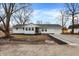 Charming single-story home with white siding, updated landscaping, and an attached one-car garage at 8810 Beechwood Ave, Indianapolis, IN 46219
