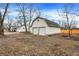 Two-car garage with mature trees, spacious side yard, and convenient backyard access at 8810 Beechwood Ave, Indianapolis, IN 46219