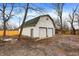 Detached two-car garage with white siding and a classic gable roof, offering ample storage space at 8810 Beechwood Ave, Indianapolis, IN 46219