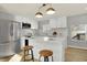 Modern kitchen with white cabinets, quartz countertops and island at 8810 Beechwood Ave, Indianapolis, IN 46219