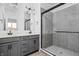 Modern bathroom with double vanity, large shower, and gray tile at 1302 English Ave, Indianapolis, IN 46203