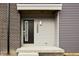 Contemporary townhome entrance with black door and gray siding at 1302 English Ave, Indianapolis, IN 46203