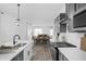 Open concept kitchen with gray cabinets and white countertops at 1302 English Ave, Indianapolis, IN 46203