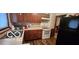 Efficient kitchen with wood cabinets, white appliances, and vinyl flooring at 1313 S Riley Ave, Indianapolis, IN 46203