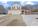 Two-story house with a brown roof, attached garage, and snow-covered driveway at 14154 Stonewood Pl, Fishers, IN 46037