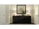 Modern entryway with dark console table, lamps, and artwork at 15352 Manderley St, Fishers, IN 46040