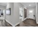 Bright hallway with hardwood floors and view into living area at 19381 Sumrall Pl, Westfield, IN 46074