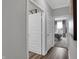 Bright hallway with two closed doors and view of bedroom at 19381 Sumrall Pl, Westfield, IN 46074