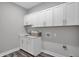 Laundry room with white cabinets and a countertop sink at 19381 Sumrall Pl, Westfield, IN 46074