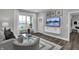 Living room with gray sofa and built-in media console at 19381 Sumrall Pl, Westfield, IN 46074