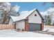 Brick home with gray garage door and snow covered yard, side view at 2050 Monroe Dr, Indianapolis, IN 46229