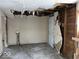 Unfinished laundry area with exposed pipes and damaged walls at 2729 Columbia Ave, Indianapolis, IN 46205