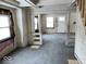 A living room undergoing renovation, featuring hardwood floors and exposed beams at 2729 Columbia Ave, Indianapolis, IN 46205