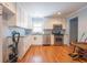 Modern kitchen with white cabinets, stainless steel appliances, and hardwood floors at 345 E Hickory Ln, Indianapolis, IN 46227