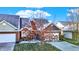 Brick front exterior with attached garage and mature tree at 3457 Heathcliff Ct, Westfield, IN 46074