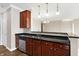 Kitchen with dark wood cabinets and granite countertops at 3457 Heathcliff Ct, Westfield, IN 46074