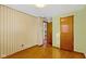 Bedroom with hardwood floors, wood door, and wallpaper at 4433 Pitt St, Anderson, IN 46013