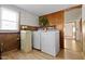 Laundry room with washer, dryer, and wood paneling at 4433 Pitt St, Anderson, IN 46013