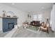 Spacious living room with fireplace, hardwood floors, and mid-century modern furniture at 4724 E New York St, Indianapolis, IN 46201