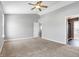 Large bedroom with ceiling fan and plush carpeting at 5632 Wild Horse Dr, Indianapolis, IN 46239