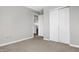 Simple bedroom with neutral walls, carpeting, and double doors at 5632 Wild Horse Dr, Indianapolis, IN 46239