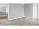 Spacious bedroom with neutral walls and carpet, near hallway at 5632 Wild Horse Dr, Indianapolis, IN 46239