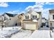 Two-story house with attached garage, brick and vinyl siding, snow-covered yard at 5632 Wild Horse Dr, Indianapolis, IN 46239