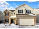 Two-story house with brick and vinyl siding, two-car garage, and snow-covered yard at 5632 Wild Horse Dr, Indianapolis, IN 46239