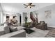 Open living room showcasing hardwood floors, a dining area, and a staircase at 5632 Wild Horse Dr, Indianapolis, IN 46239