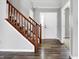 Wooden staircase with brown railing and gray walls at 5632 Wild Horse Dr, Indianapolis, IN 46239