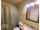 Clean bathroom with light walls, a shower/tub combo, and updated vanity at 5721 Shimer Ave, Indianapolis, IN 46219