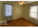 Well-lit bedroom featuring hardwood floors and neutral-toned walls at 5721 Shimer Ave, Indianapolis, IN 46219