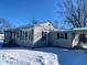 Ranch home with covered porch and snowy yard at 5721 Shimer Ave, Indianapolis, IN 46219