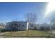 Charming single-story home featuring a cozy porch and well-maintained front yard, secured by a chain link fence at 5721 Shimer Ave, Indianapolis, IN 46219