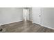 Bedroom featuring neutral paint and wood-look floors, plus a view into the bath at 5807 Westhaven Dr, Indianapolis, IN 46254