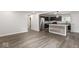 Open-concept view into kitchen with an island featuring stainless steel appliances and dark blue cabinets at 5807 Westhaven Dr, Indianapolis, IN 46254