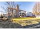 Expansive backyard featuring a large lawn, mature trees, and a swing for relaxation at 5838 W Bayfield Dr, McCordsville, IN 46055