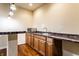 Close-up of basement bar with sink, microwave, custom wood cabinets and bar top at 5838 W Bayfield Dr, McCordsville, IN 46055