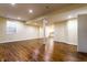Open basement space with wooden floors and an abundance of natural light from window at 5838 W Bayfield Dr, McCordsville, IN 46055