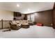 Finished basement with a cozy seating area, plush carpeting, and ample space for entertaining at 5838 W Bayfield Dr, McCordsville, IN 46055