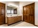 Bathroom featuring a double sink vanity with wood cabinetry and a large mirror at 5838 W Bayfield Dr, McCordsville, IN 46055