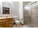 Cozy bathroom with a single sink vanity, toilet, and a glass-enclosed shower for added convenience at 5838 W Bayfield Dr, McCordsville, IN 46055