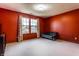 Bedroom featuring bright red walls, a double window, and a black futon at 5838 W Bayfield Dr, McCordsville, IN 46055