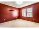 Bedroom featuring red walls, plush carpet, and a double window that provides ample natural light at 5838 W Bayfield Dr, McCordsville, IN 46055