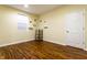 A bright bedroom with wood flooring and a ladder-style shelf between a window and door at 5838 W Bayfield Dr, McCordsville, IN 46055