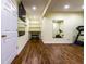 Home gym with sleek wood flooring, wall-mounted TV, and exercise equipment at 5838 W Bayfield Dr, McCordsville, IN 46055